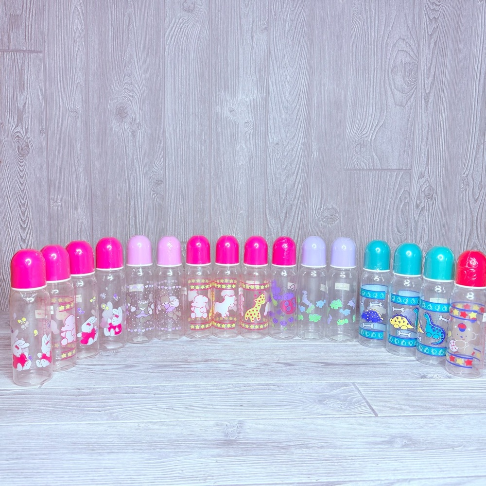 Vintage lot of 16 baby bottles angels , dinosaurs , bunny’s , bears sports